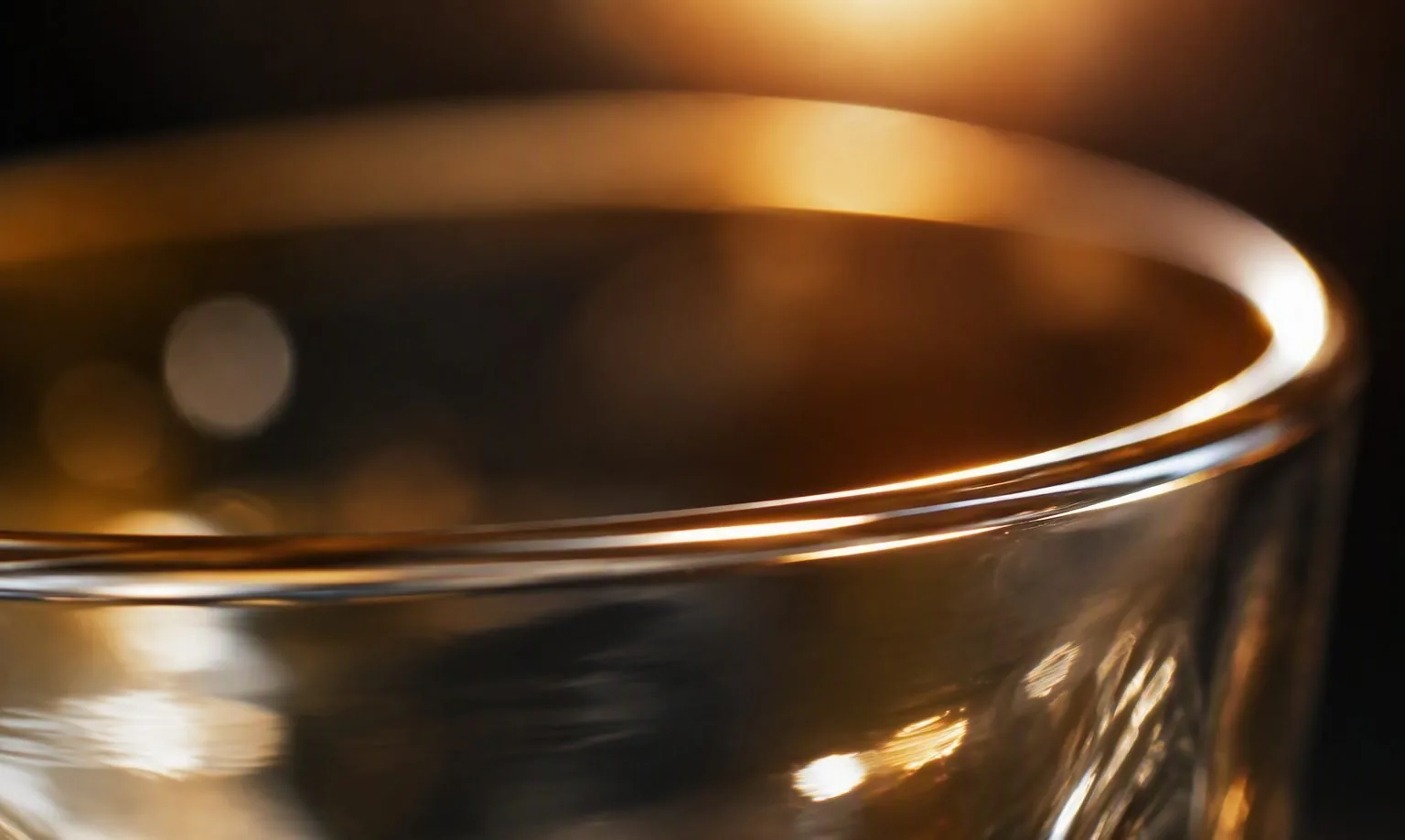 Artisan rotating a glass against a flame to fire-polish the rim